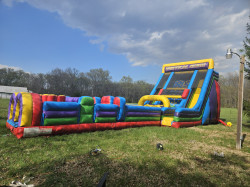 Vertical Rush 22' tall rock wall with slide and obstacle cou