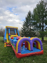 received 631073522533772 1712529475 Vertical Rush 22' tall rock wall with slide and obstacle cou